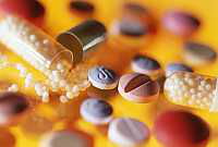 The photo shows a colourful mixture of different tablets.